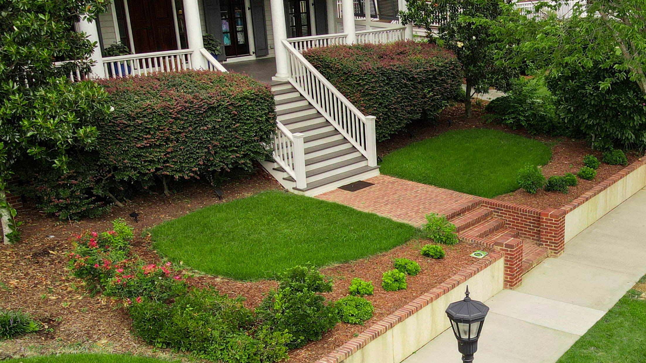 Aerial view of a residential home with a healthy lawn maintained by Lawn Ace, providing local lawn care services in Augusta and the CSRA.