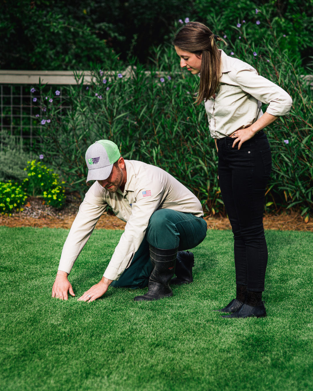 lawn company near me in grovetown tech showing a customer a green weed free lawn